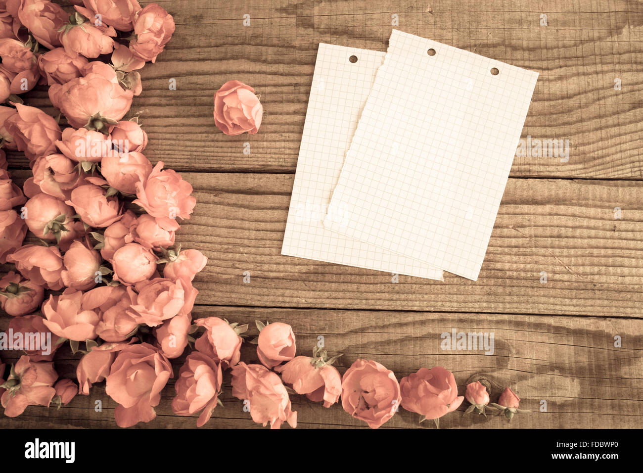block notes and red roses on wooden background, vintage denim effect ...