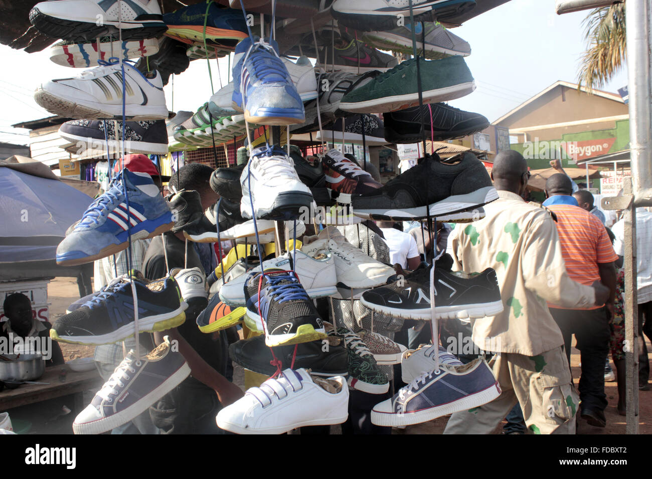 Shoes on sale at a market in Uganda Stock Photo - Alamy