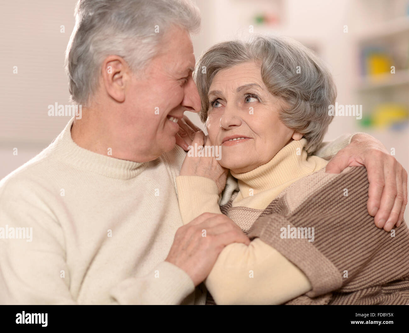 Elderly people sitting on couch Stock Photo