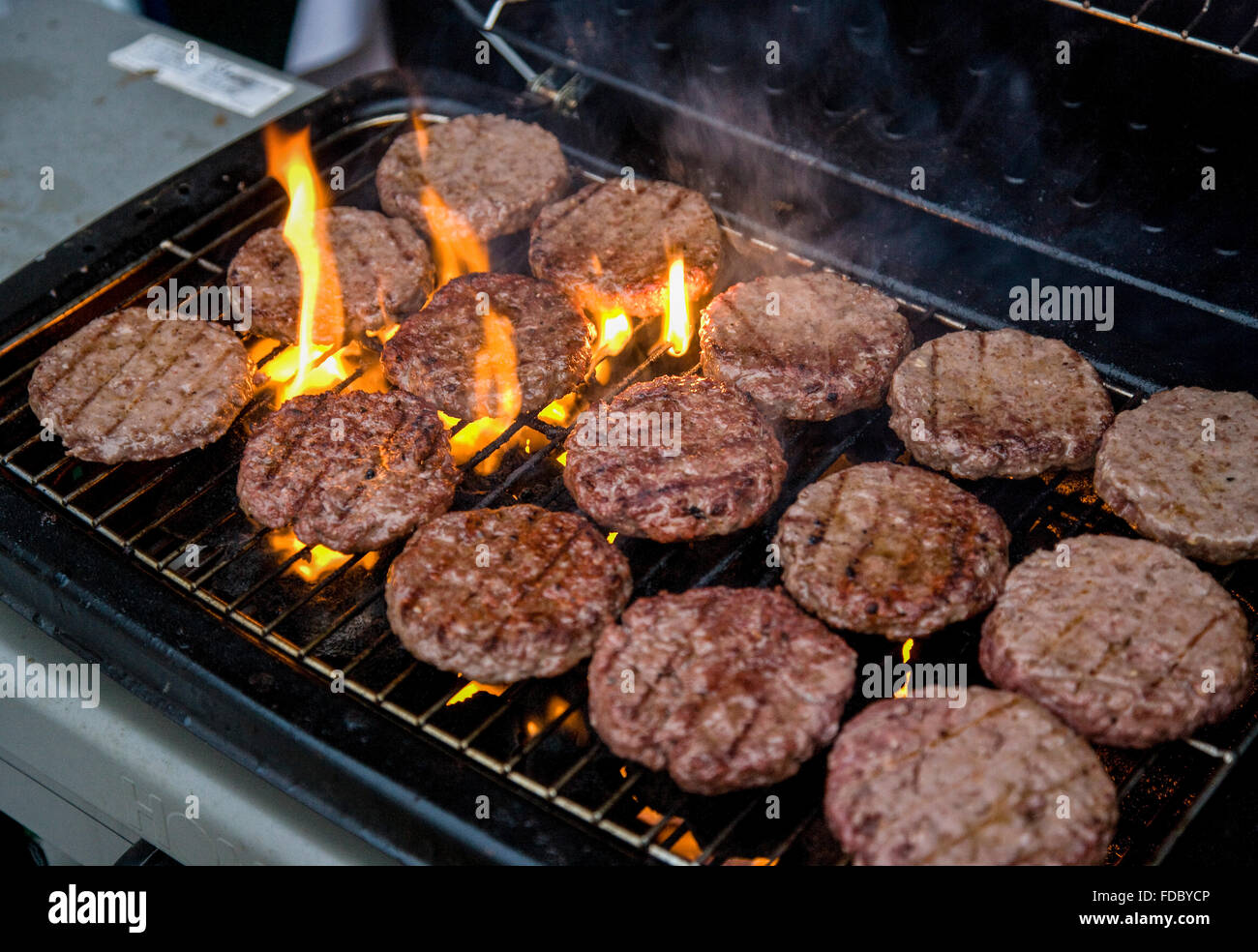 Flame grilled beef burgers on a barbecue BBQ Stock Photo - Alamy