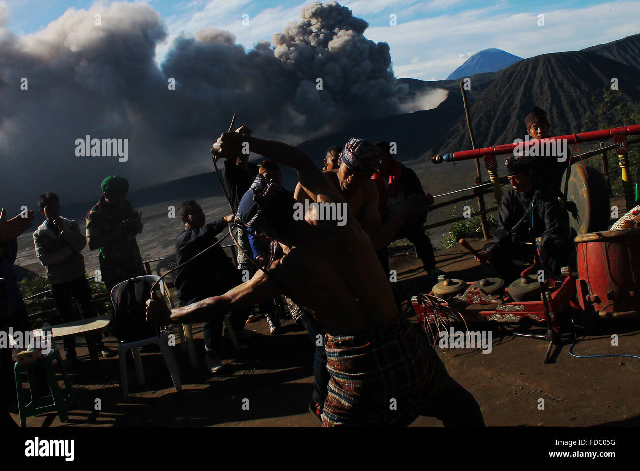 Probolinggo, EAST JAVA, INDONESIA. 30th Jan, 2016. Tenggerese performs a traditional dance called ''Ujung-Ujungan'' while the eruption of Mount Bromo in Probolinggo, East Java, on January 30, 2016. The ''Ujung-Ujung'' dance is one of the traditional dance and sports a distinctive combination of Tengger tribe, in the region of Mount Bromo in Probolinggo, East Java. This dance is played by two men who alternated hitting the opponent by using rattan. Credit:  Suryanto/ZUMA Wire/Alamy Live News Stock Photo