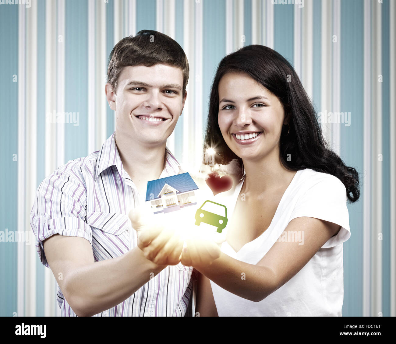 Happy young couple holding model of house on palms Stock Photo - Alamy
