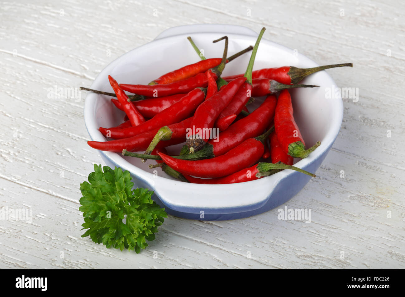 Red hot chili peppers heap on the wood background Stock Photo - Alamy