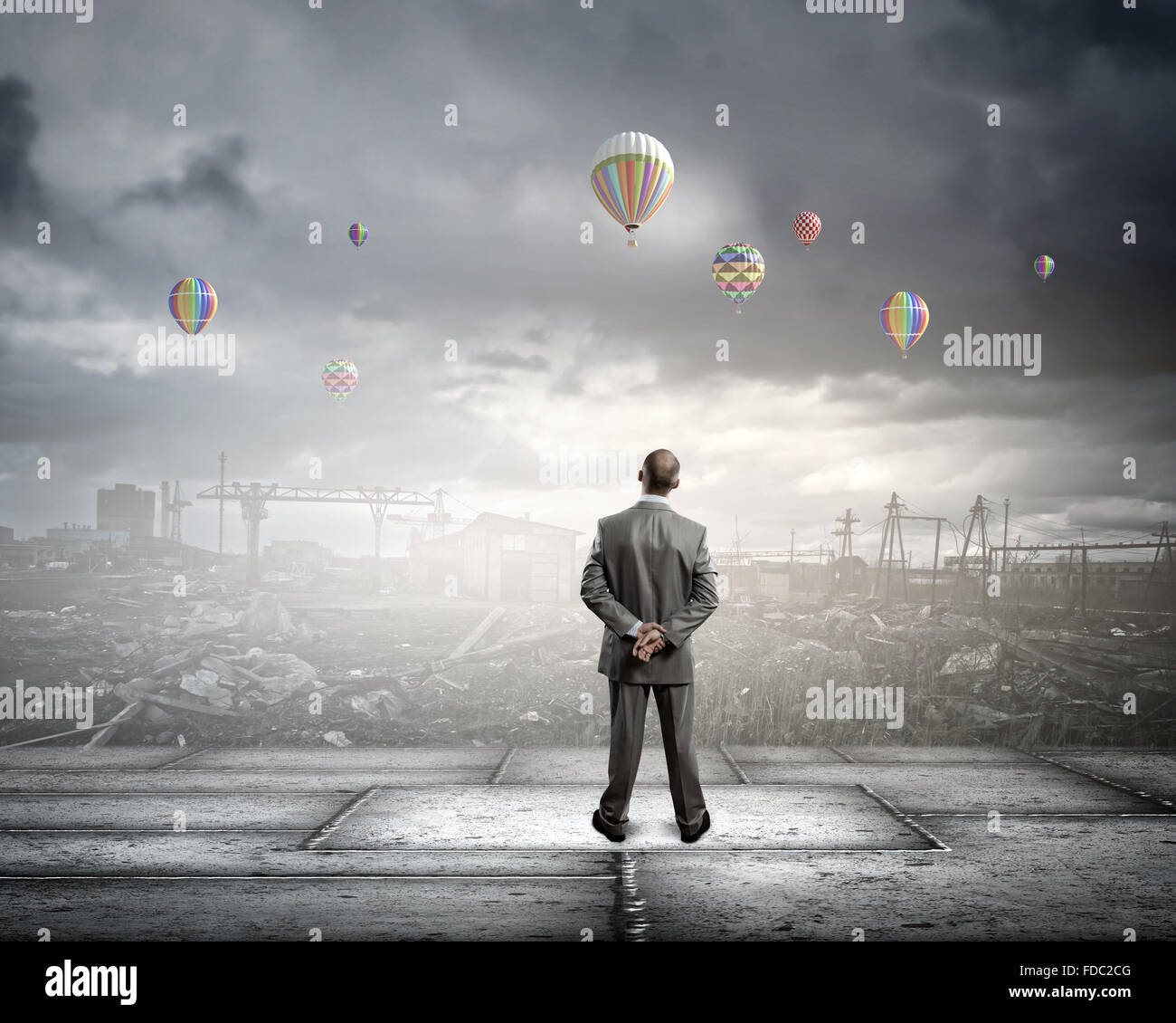 Rear view of businessman looking at aerostats flying above city Stock ...