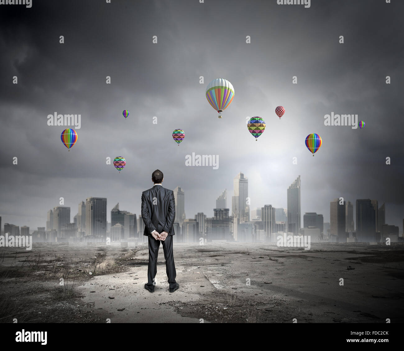 Rear view of businessman looking at aerostats flying above city Stock ...
