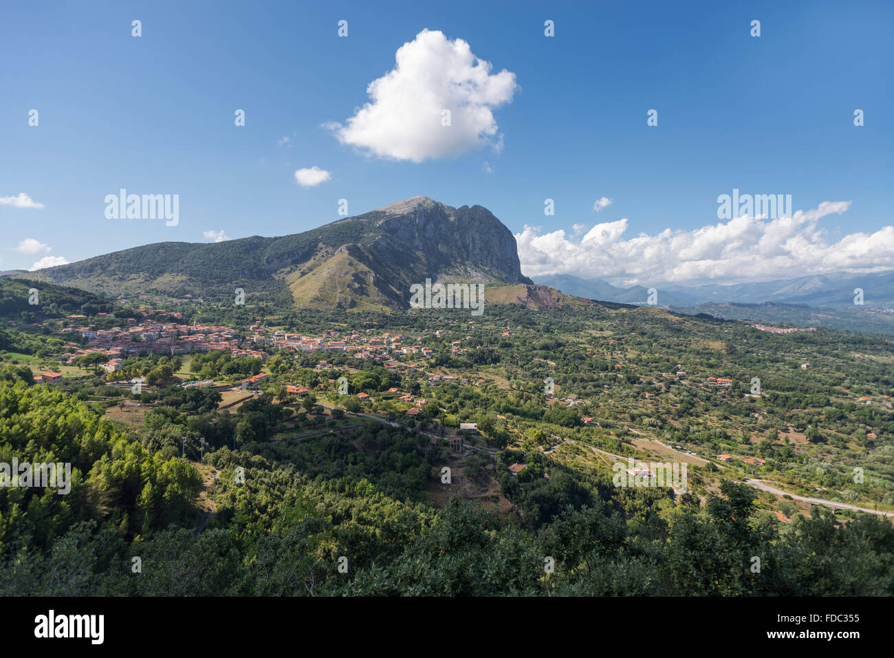 The mountain range of Monte Bulgheria and the township of San Giovanni a Piro in Cilento in afternoon sunlight, Campania, Italy Stock Photo
