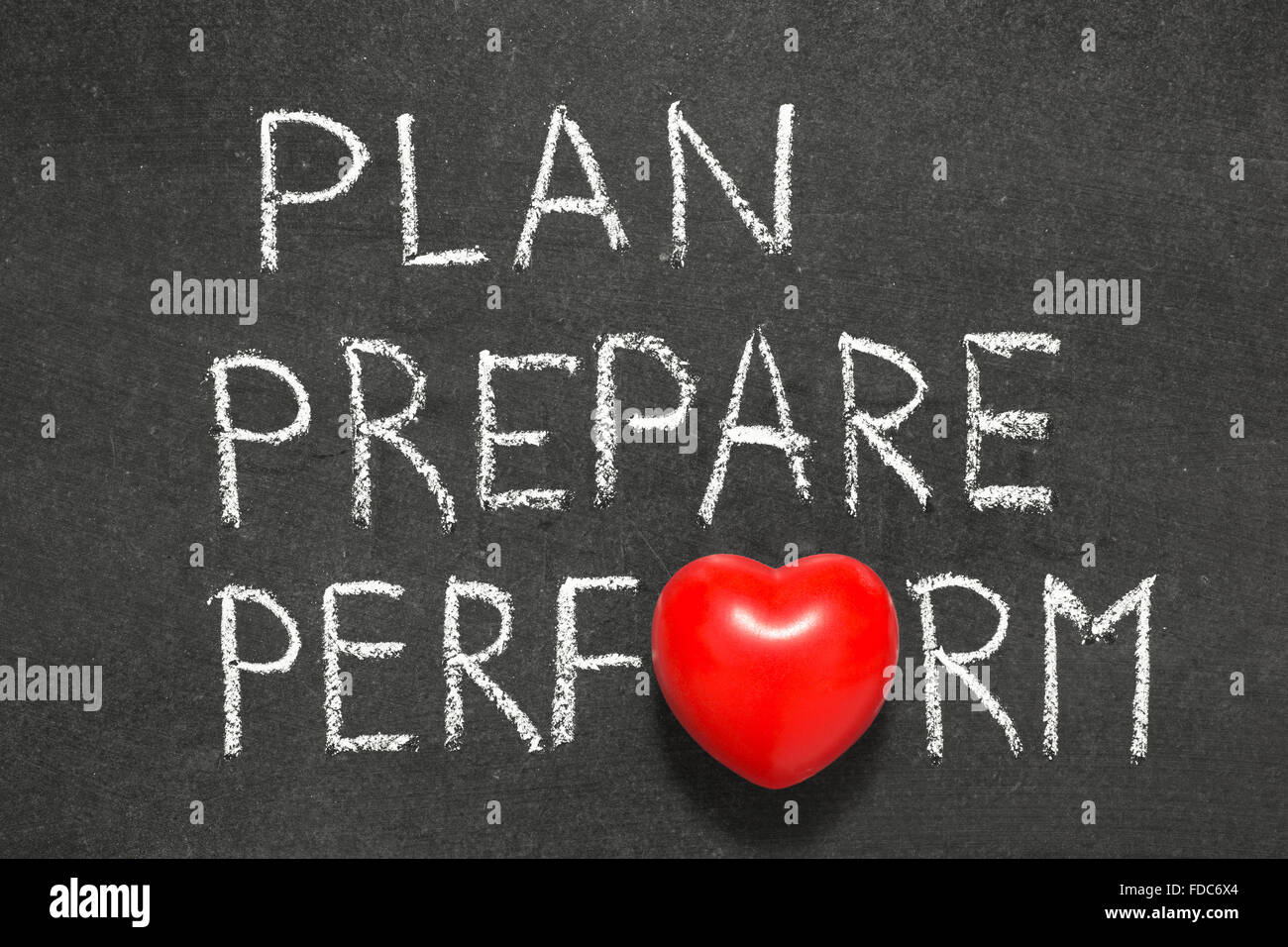 plan,prepare and perform phrase handwritten on blackboard with heart symbol instead O Stock Photo