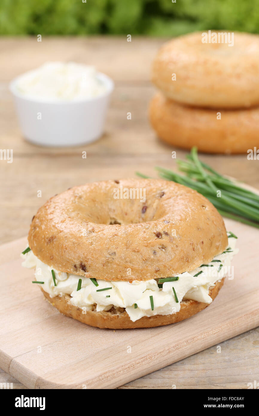 Banana and blueberry bagel with cream cheese on a pastel pink background  Stock Photo