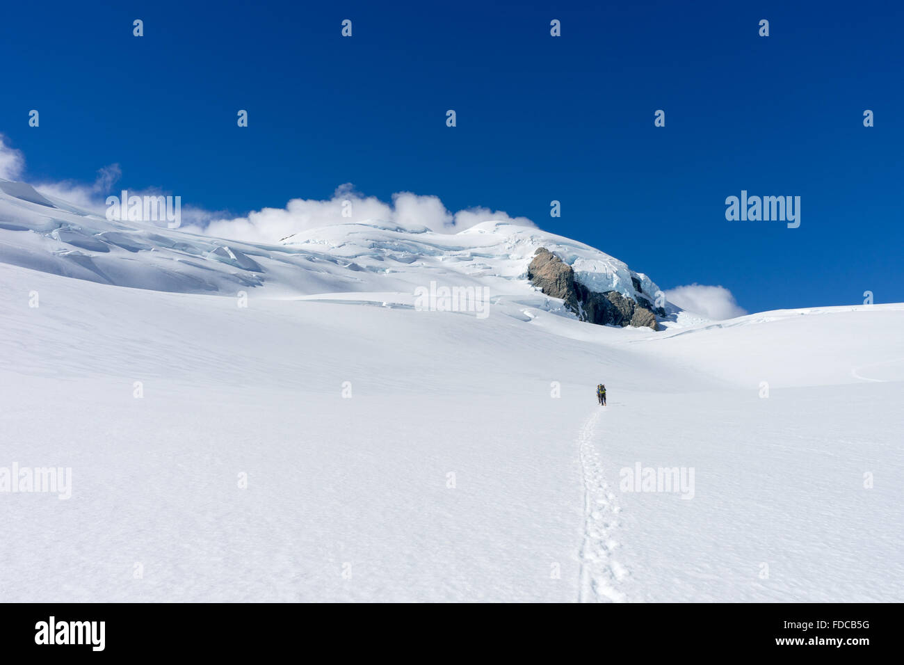 People walking among snows of New Zealand mountains Stock Photo