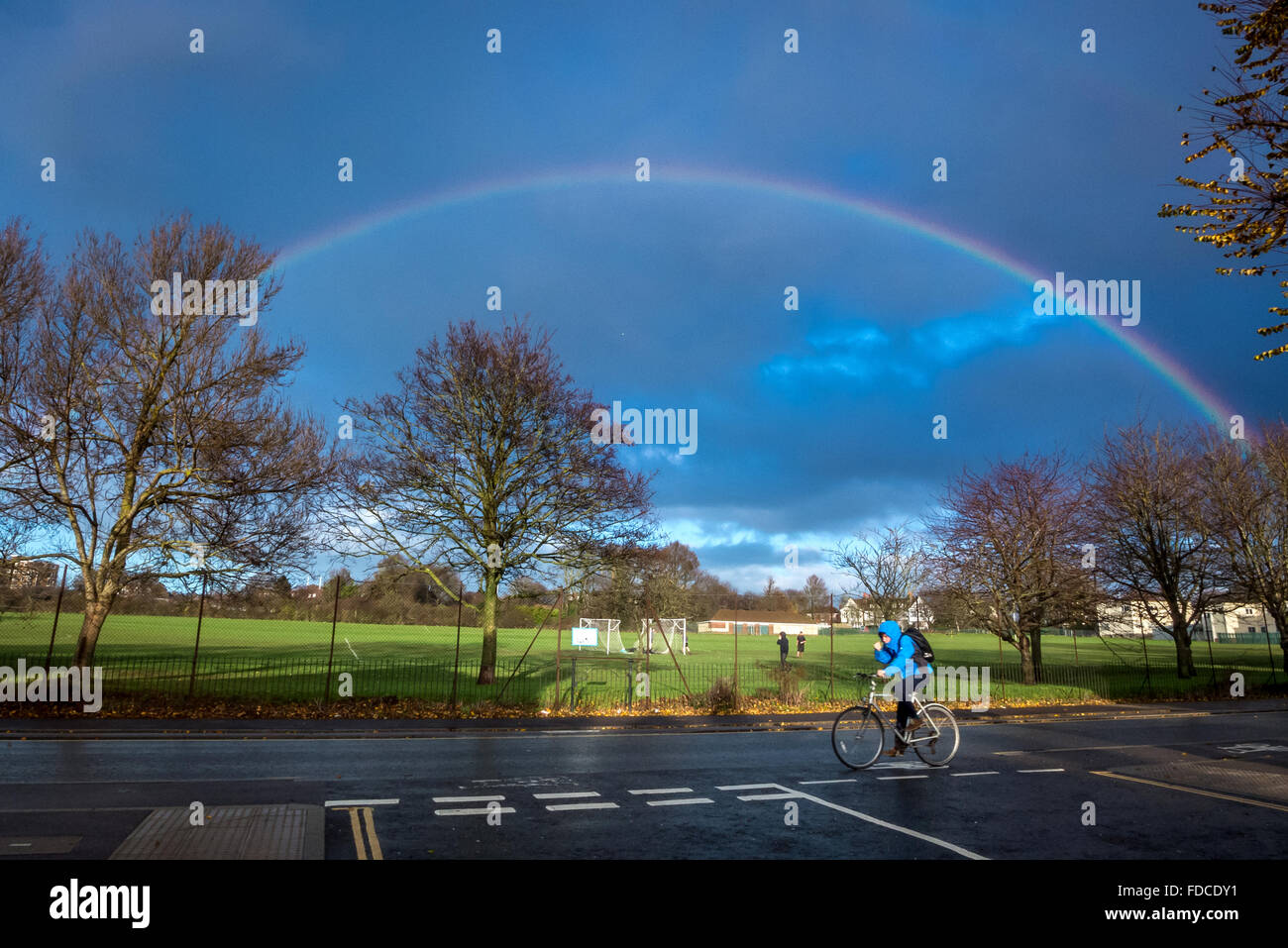 A full-arc rainbow over playing fields in Brighton and Hove Stock Photo