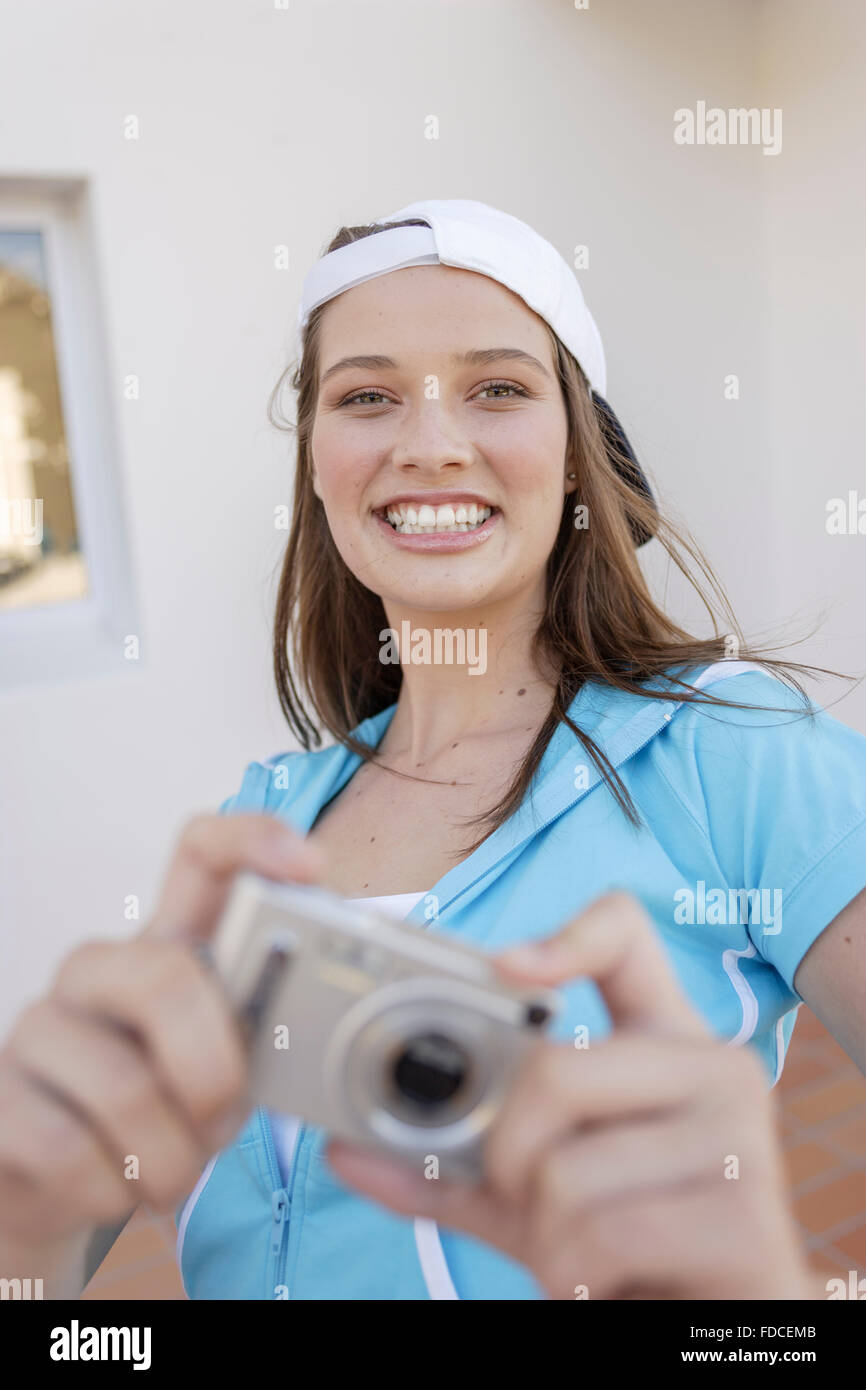 Young woman using digital camera Stock Photo