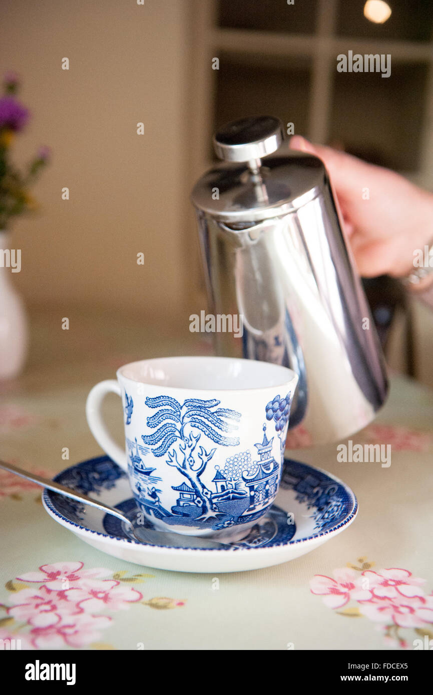 Pouring tea into bone china tea cup and saucer at Drum Castle in Aberdeenshire, Scotland. Stock Photo