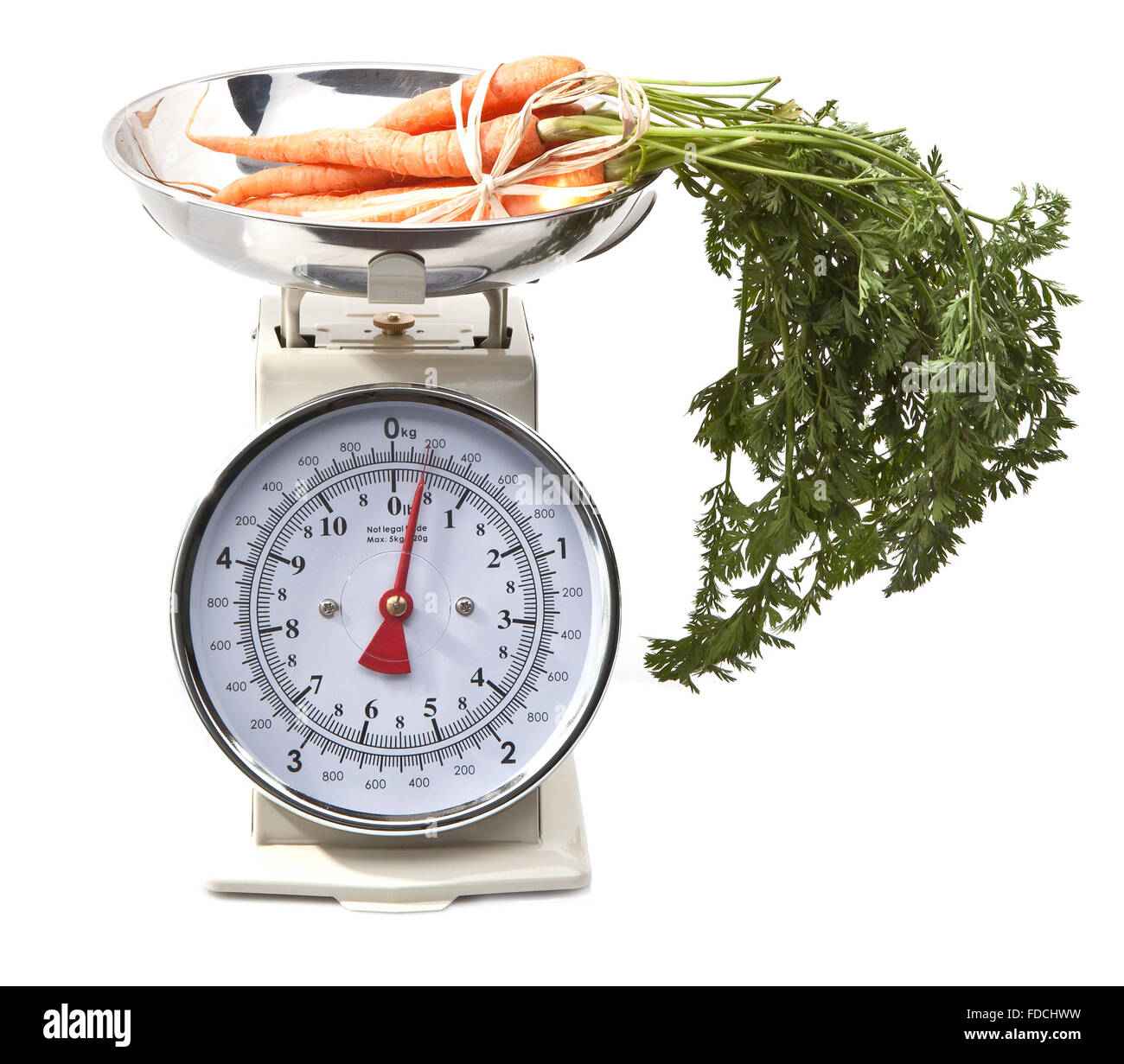 Old style kitchen scales with carrots on white background Isolated Stock Photo