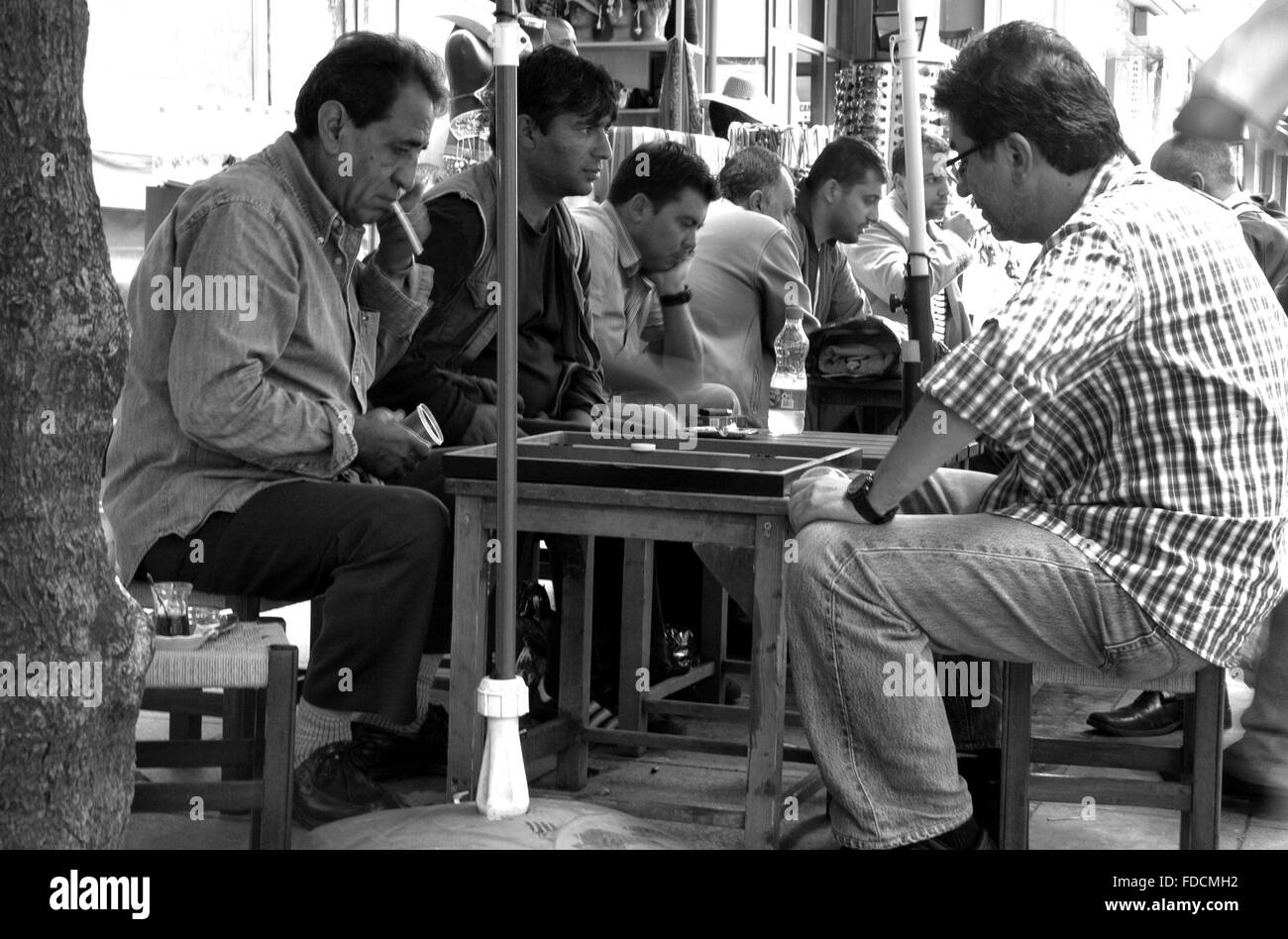 ISTANBUL - SEPT 8: Unidentified men play baccarat or tavla game in street at old quartier, Istanbul, Turkey on Sept 8, 2009 Stock Photo