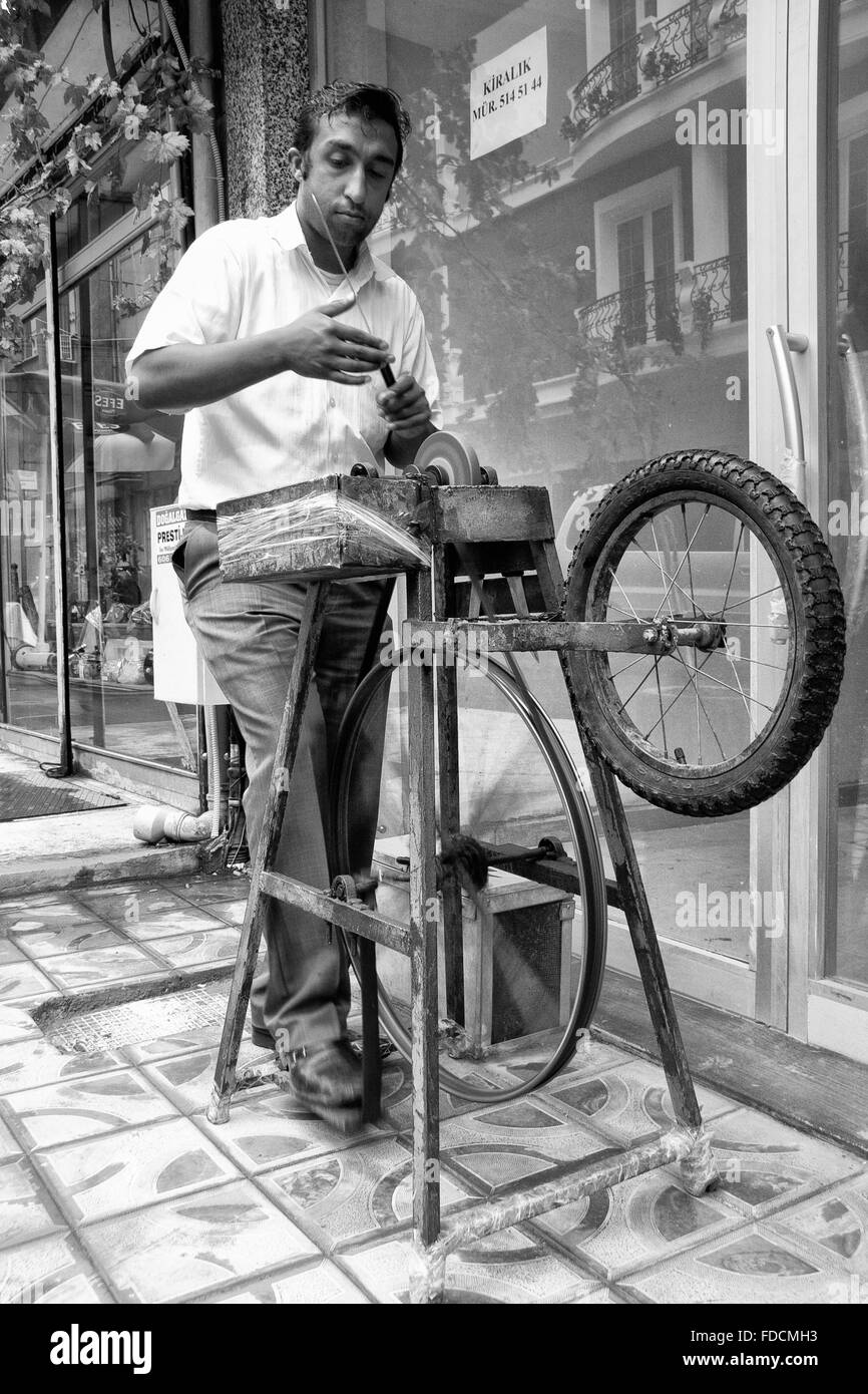ISTANBUL - SEPT 9: Unidentified street knife grinder at old quartier, Istanbul, Turkey on Sept 9, 2009 Stock Photo