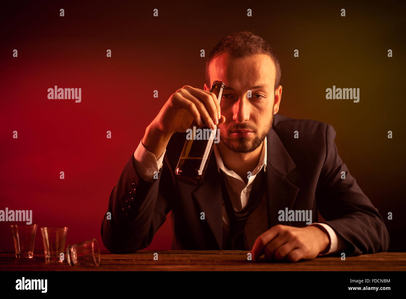 Drunk Businessman Drinking a Beer in a Pub Stock Photo