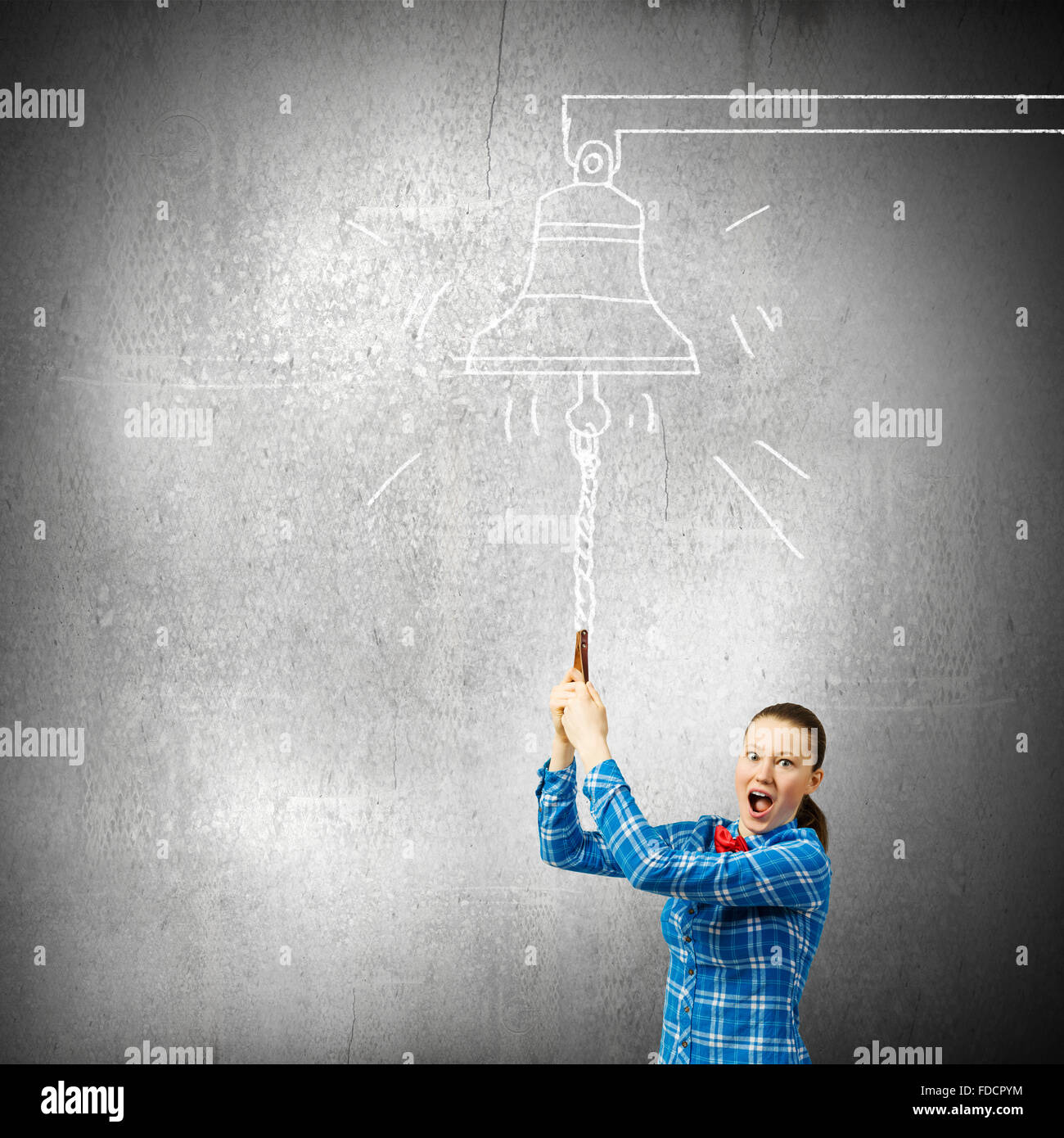 Young excited woman in casual ringing bell Stock Photo - Alamy