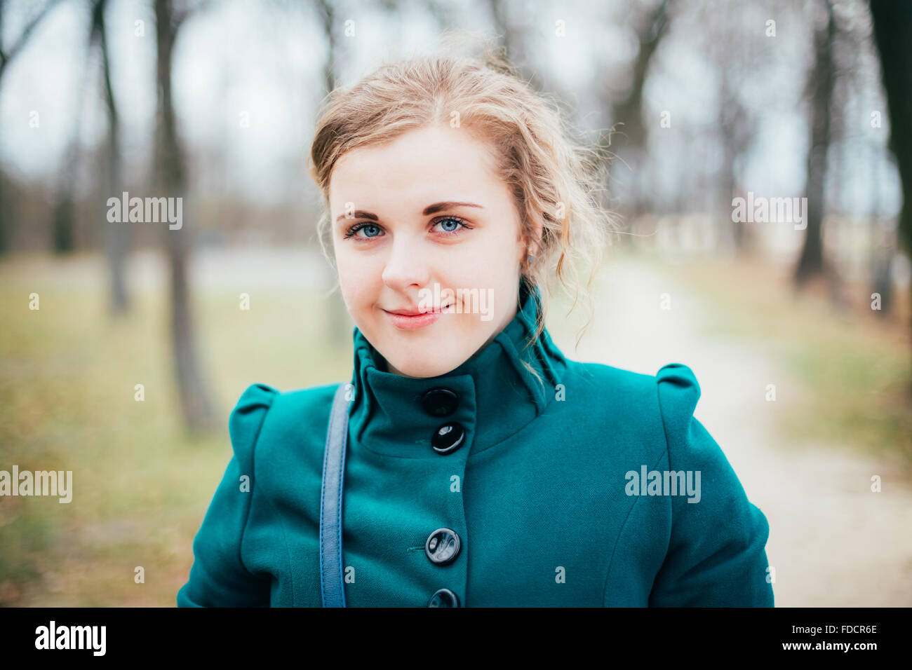 Portrait Of Beautiful Plus Size Young Woman In Blue Coat Posing In Park. Spring, Autumn Outdoor Portrait Stock Photo