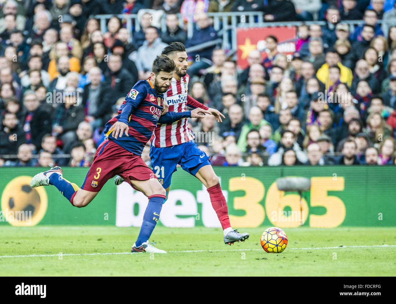 Barcelona, Catalonia, Spain. 30th Jan, 2016. FC Barcelona defender PIQUÃ‰ competes with Atletico Madrid midfielder CARRASCO for the ball during the BBVA league match between FC Barcelona and Athletic Club at the Camp Nou stadium in Barcelona Credit:  Matthias Oesterle/ZUMA Wire/Alamy Live News Stock Photo