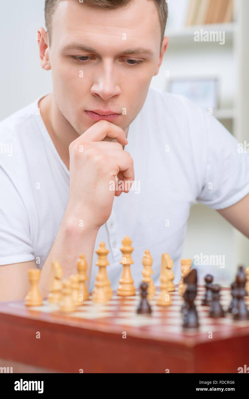 Intelligent man playing chess Stock Photo