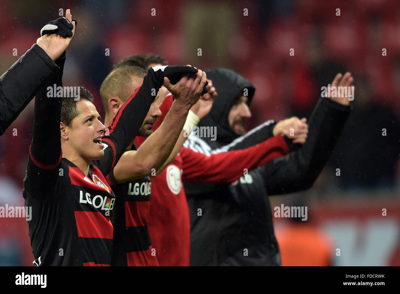 Leverkusen, Germany. 30th Jan, 2016. Leverkusen's Javier Hernandez (l) and teammates celebrate their victory after the German Bundesliga football match between Bayer Leverkusen and Hannover 96, at the BayArena in Leverkusen, Germany, 30 January 2016. PHOTO: FEDERICO GAMBARINI/DPA (EMBARGO CONDITIONS - ATTENTION: Due to the accreditation guidelines, the DFL only permits the publication and utilisation of up to 15 pictures per match on the internet and in online media during the match.) Credit:  dpa/Alamy Live News Stock Photo
