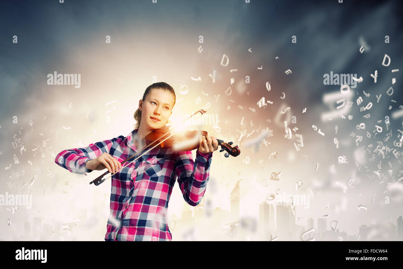 Young pretty girl in casual playing violin Stock Photo - Alamy