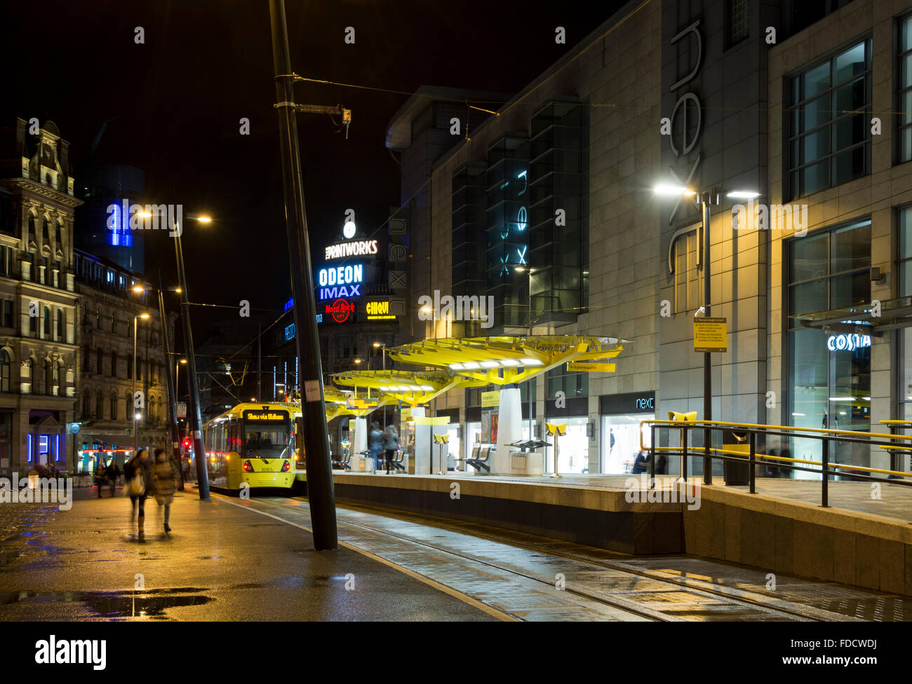 Exchange Square Metrolink tram stop at night, Corporation Street, Manchester, England, UK.  The Arndale Centre at right. Stock Photo