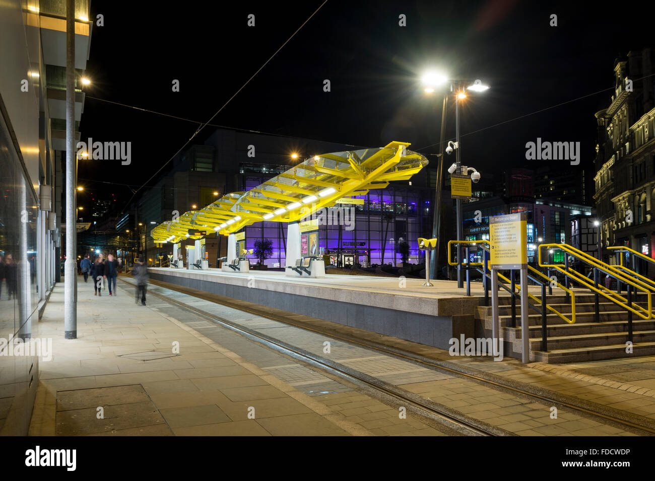 Exchange Square Metrolink tram stop at night, Corporation Street, Manchester, England, UK.  The Selfridges store behind. Stock Photo