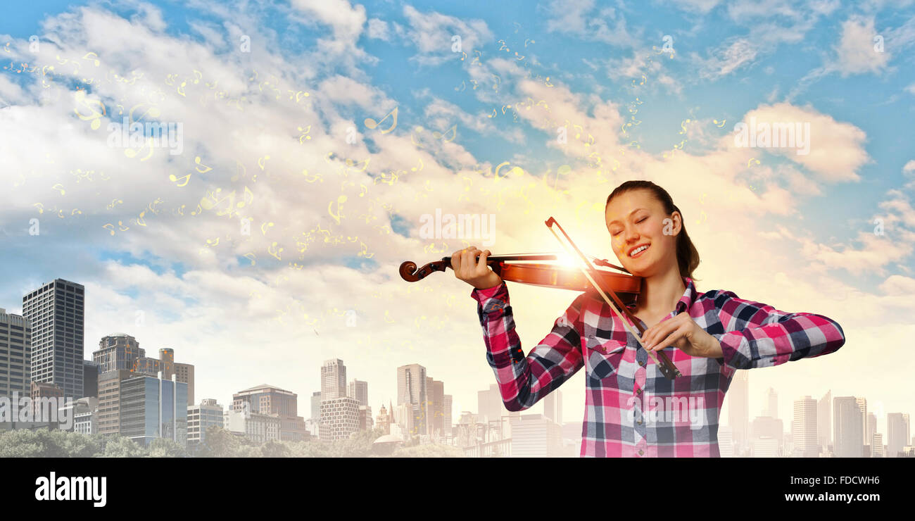 Young pretty girl in casual playing violin Stock Photo - Alamy