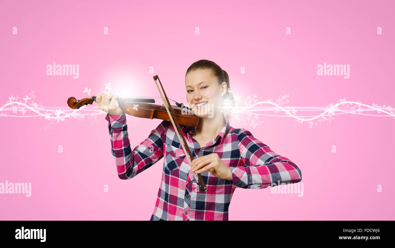 Young pretty girl in casual playing violin Stock Photo - Alamy