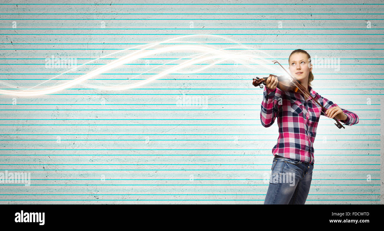 Young pretty girl in casual playing violin Stock Photo - Alamy