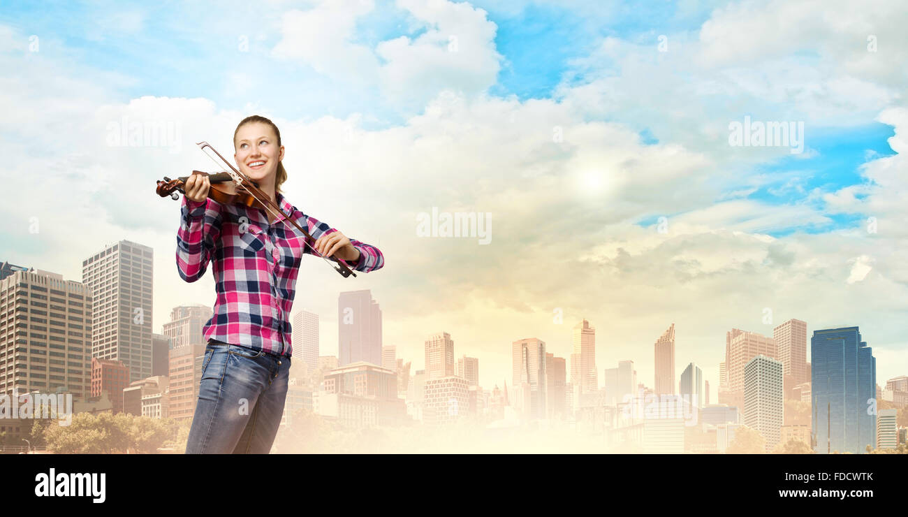 Young pretty girl in casual playing violin Stock Photo - Alamy