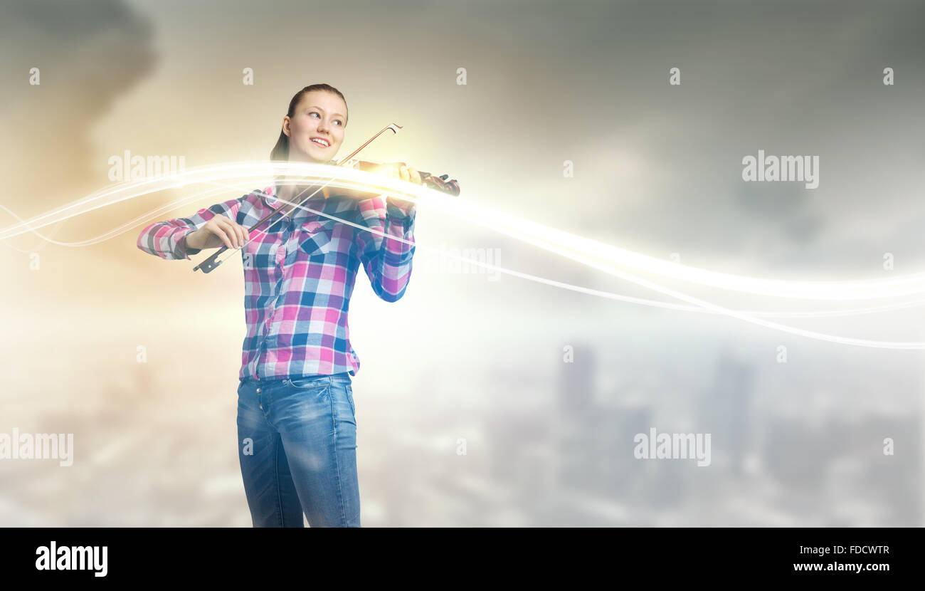 Young pretty girl in casual playing violin Stock Photo - Alamy