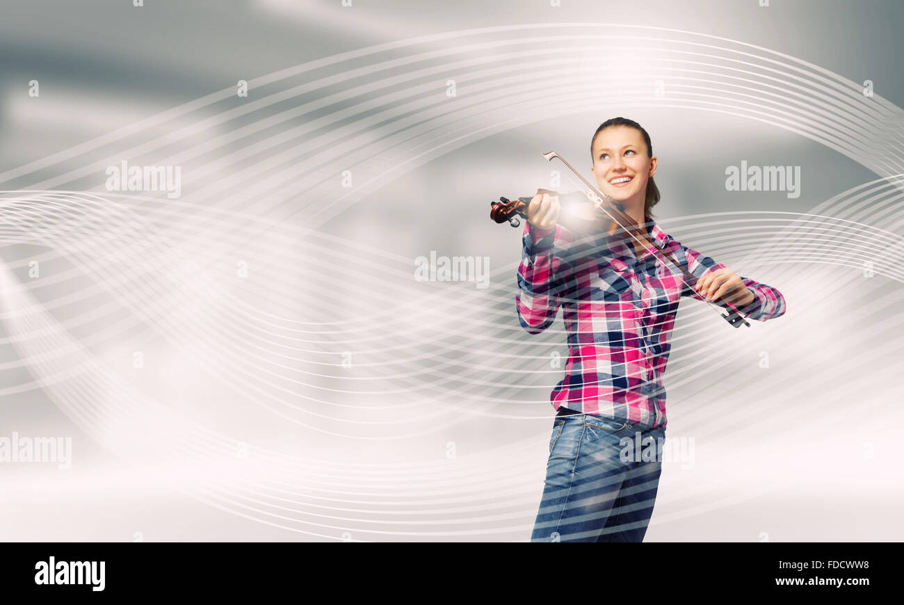 Young pretty girl in casual playing violin Stock Photo - Alamy