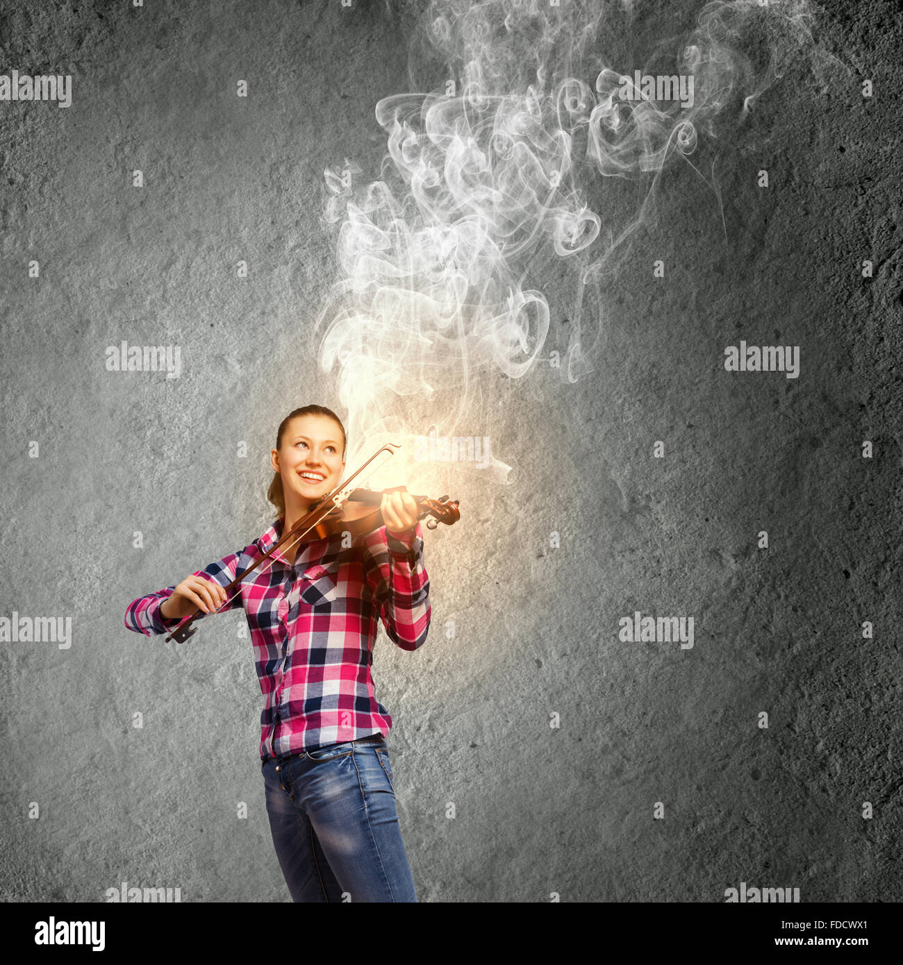 Young pretty girl in casual playing violin Stock Photo - Alamy