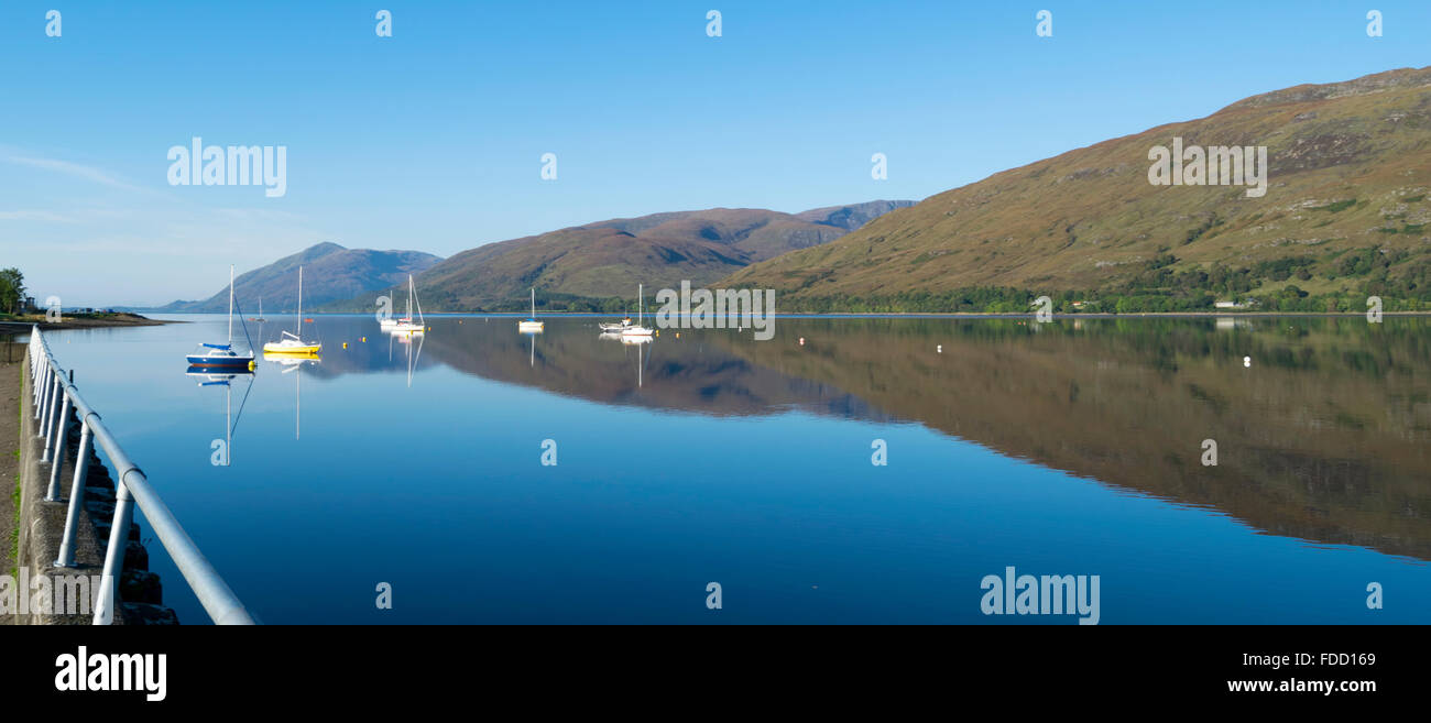 View over Loch Linnhe from Fort William on a clear day, with the highlands reflected in the water. Stock Photo