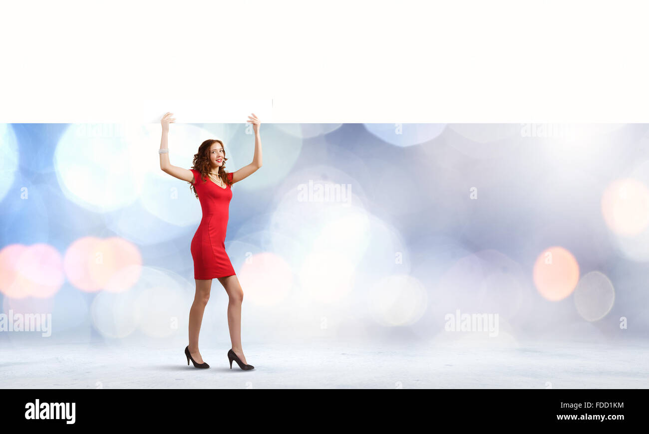 Pretty woman in red dress with white blank banner Stock Photo - Alamy