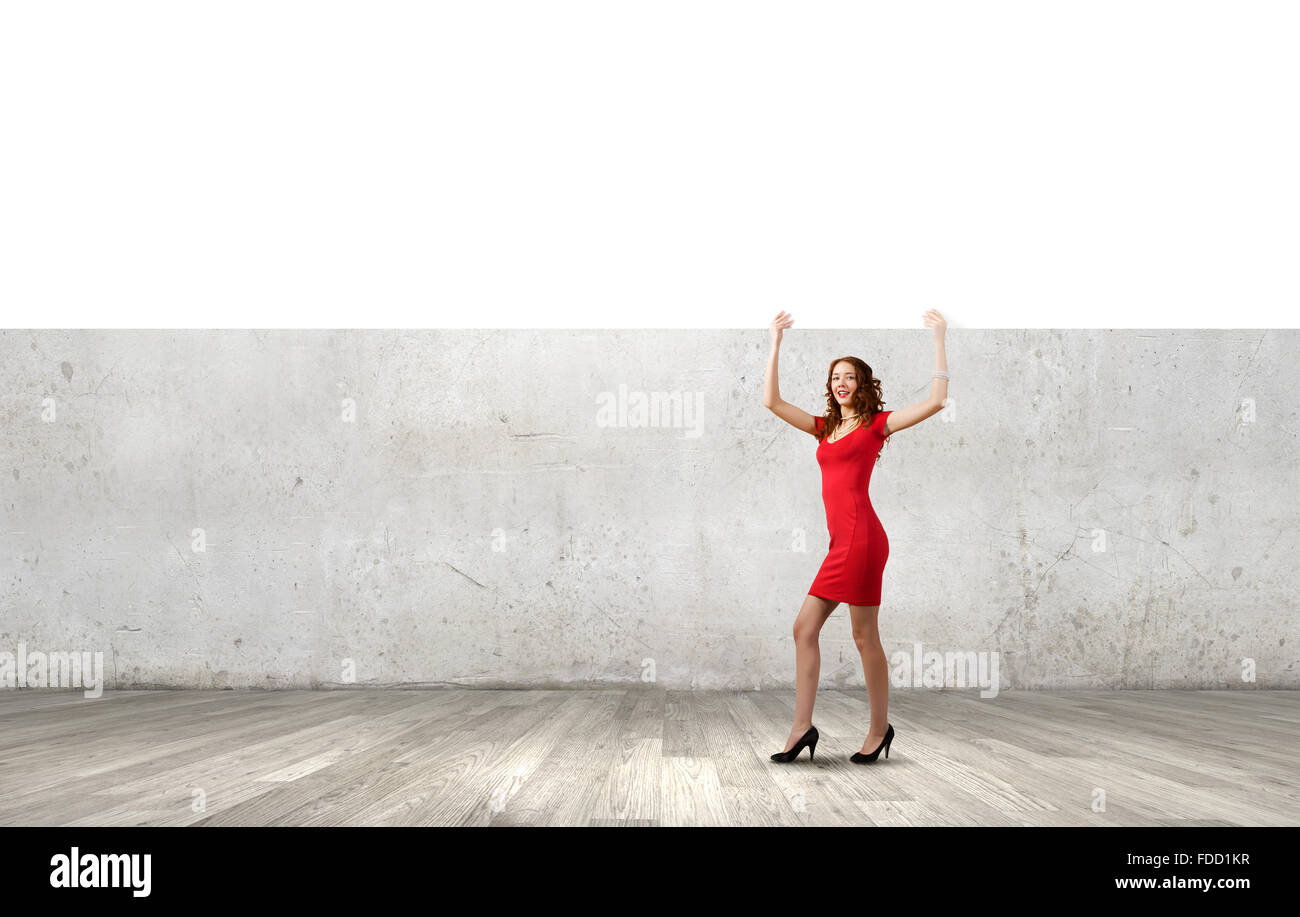Pretty woman in red dress with white blank banner Stock Photo - Alamy