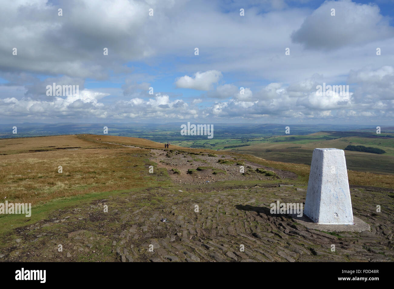 Walkers walking to Trig point at the summit of Pendle Hill in Lancashire Stock Photo