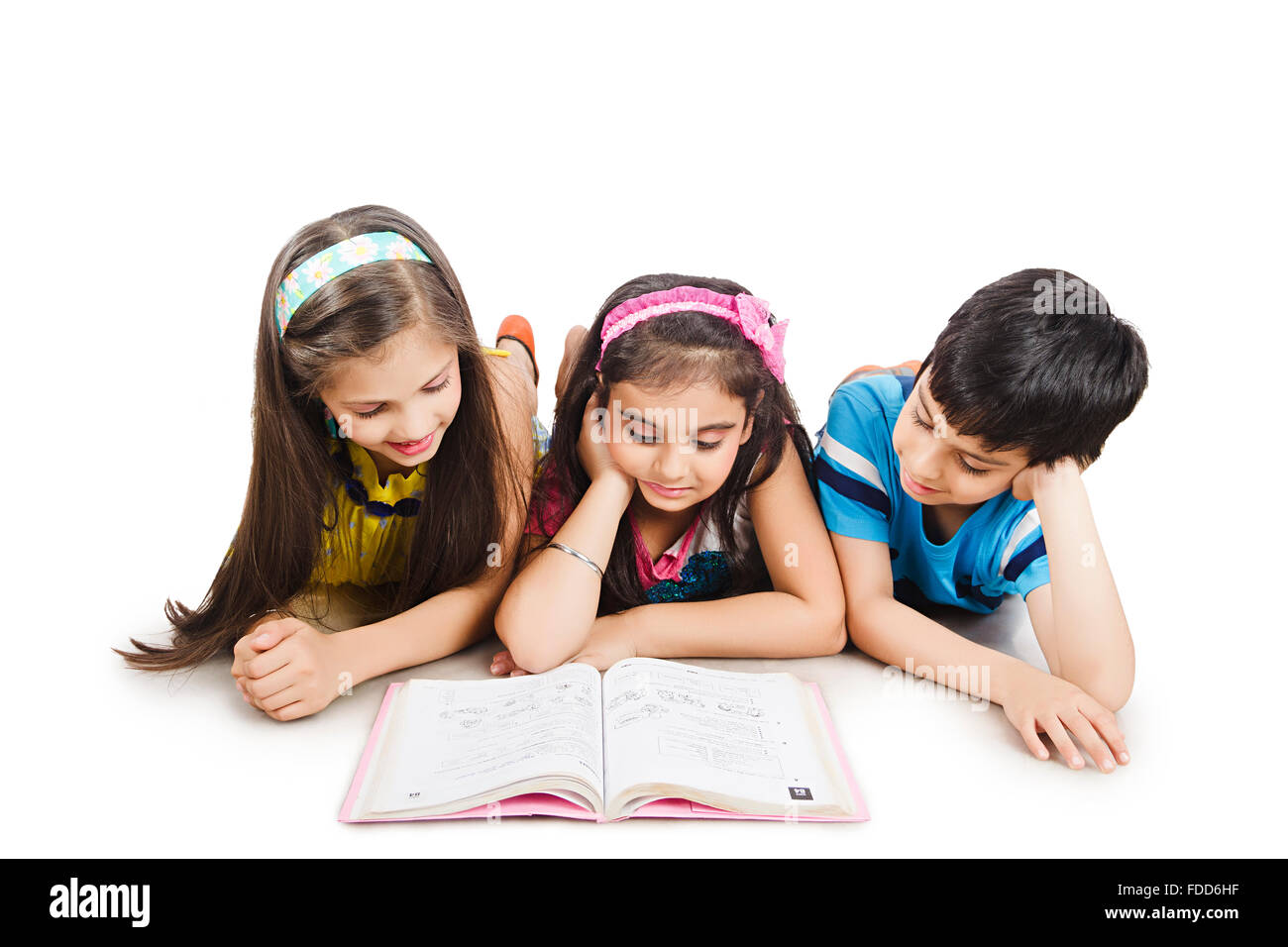 3 Kids Friends Lying Down Studying Reading Book Stock Photo - Alamy