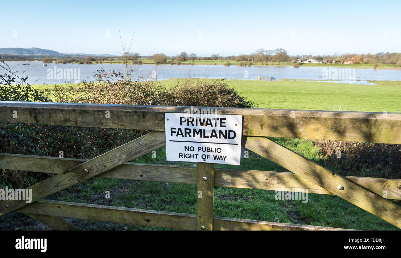 Private Farmland - No Public Right of Way sign on a wooden gate in the Sussex countryside Stock Photo