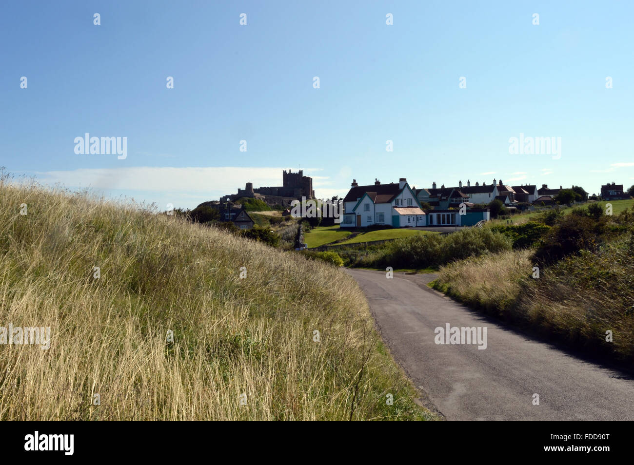 Bamburgh Castle Viewed Down The Wynding With Holiday Cottages In