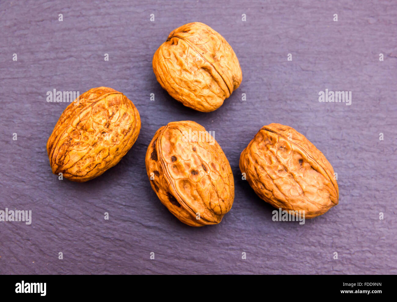 Walnuts on a slate top top views Stock Photo - Alamy