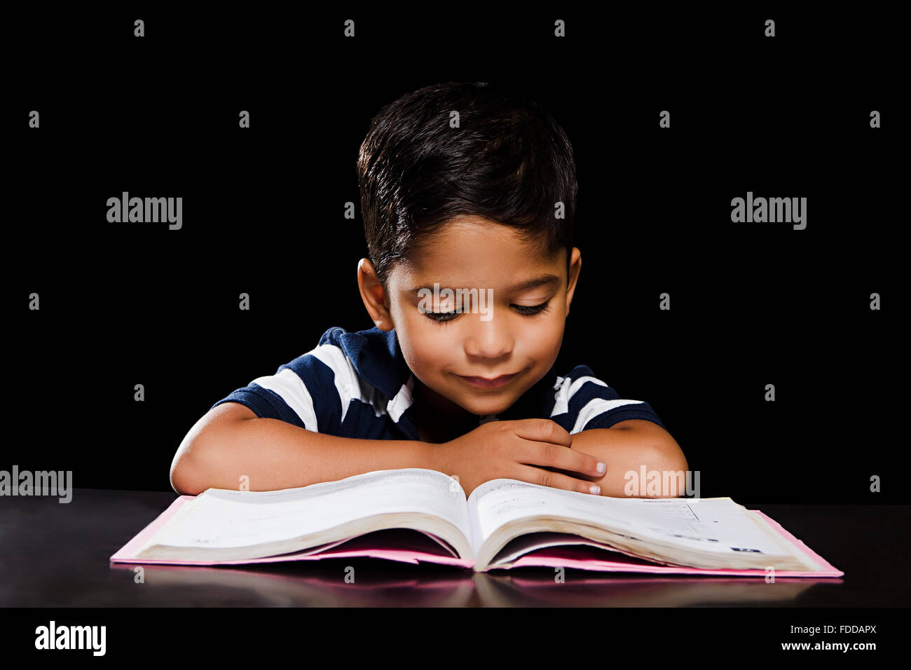 1 indian Kid Boy Student Reading Book Stock Photo