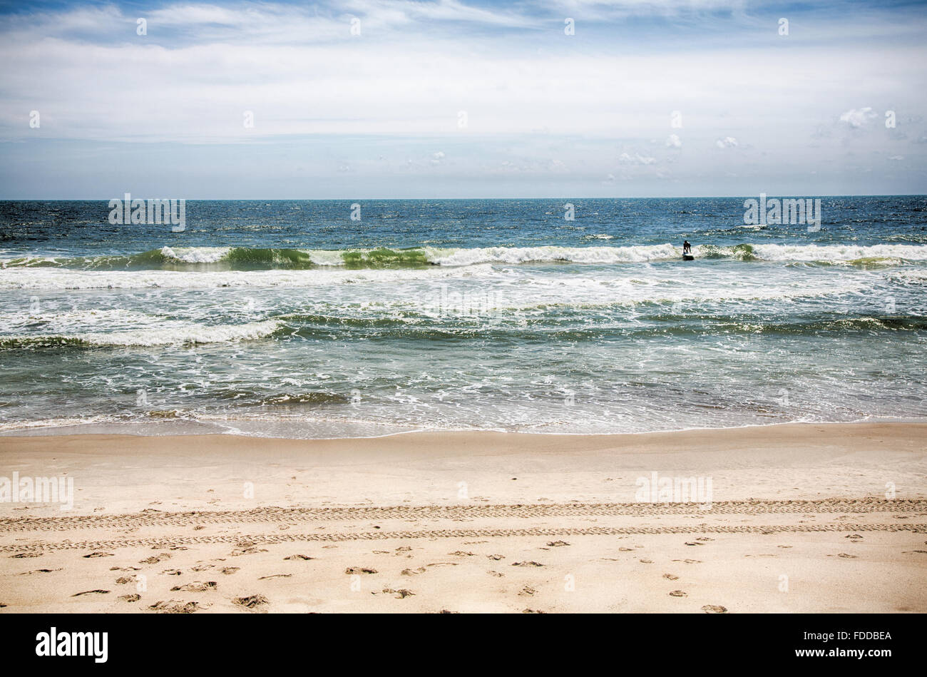 A surfer rides in a wave at Kure Beach, North Carolina Stock Photo Alamy