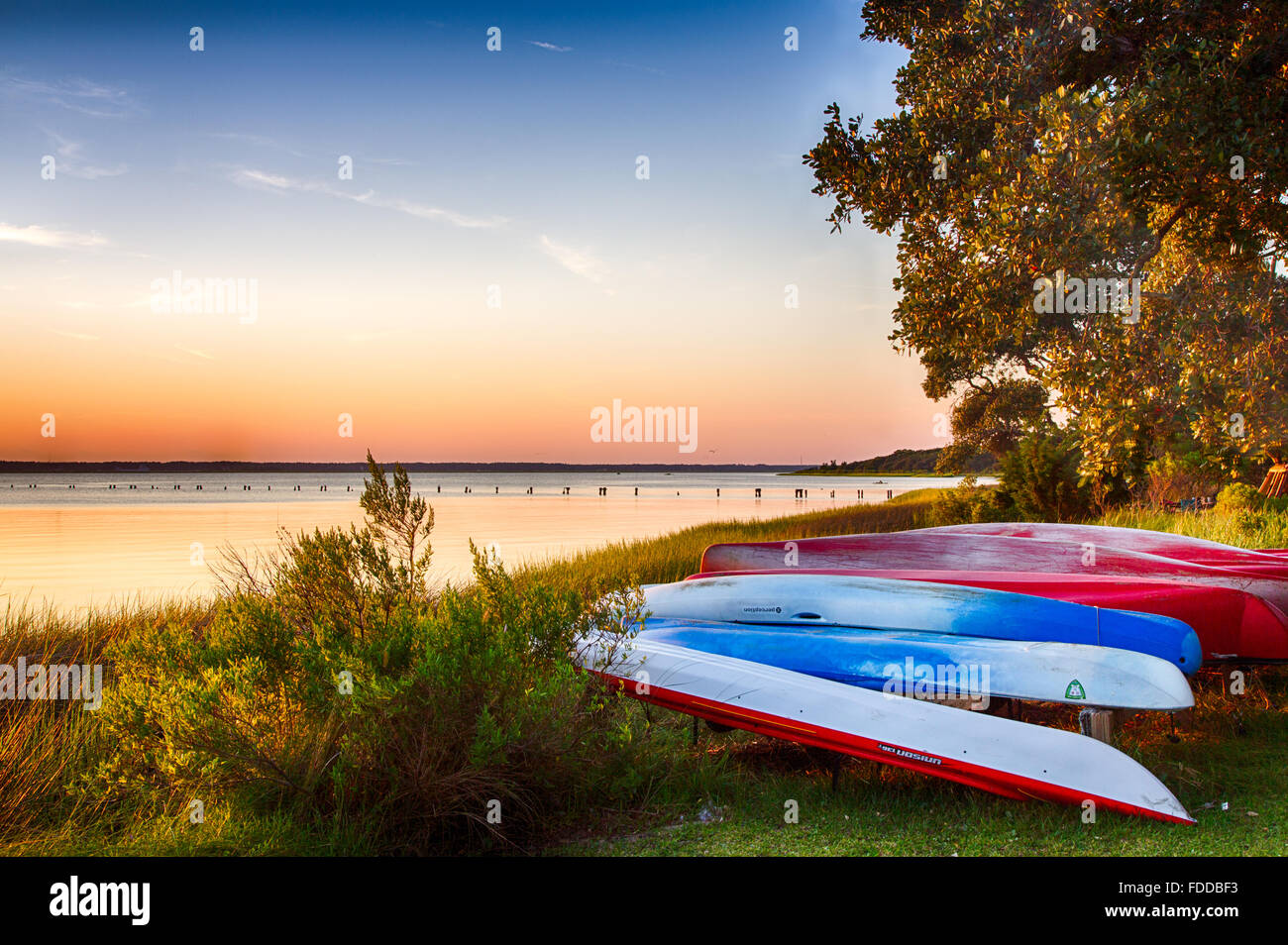 Colorful canoes on the bank of the Cape Fear River. Kure Beach, North