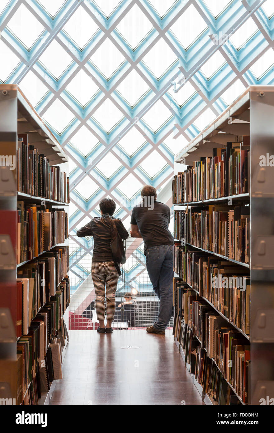 Couple looking at windows of the modern Seattle Central Library, designed by architects Rem Koolhaas and Joshua Prince-Ramus Stock Photo