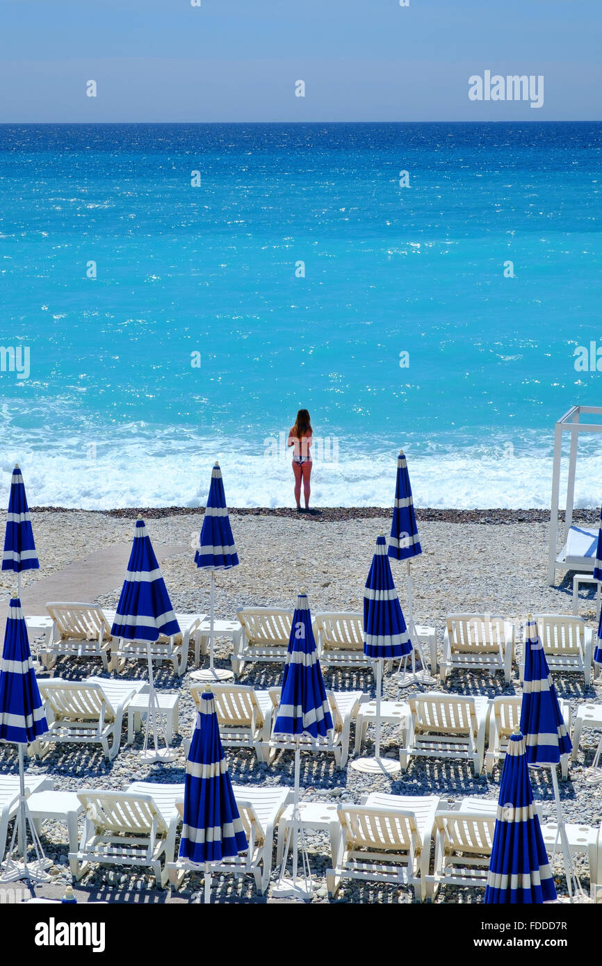 young girl summer holiday beach umbrellas sea sand Stock Photo