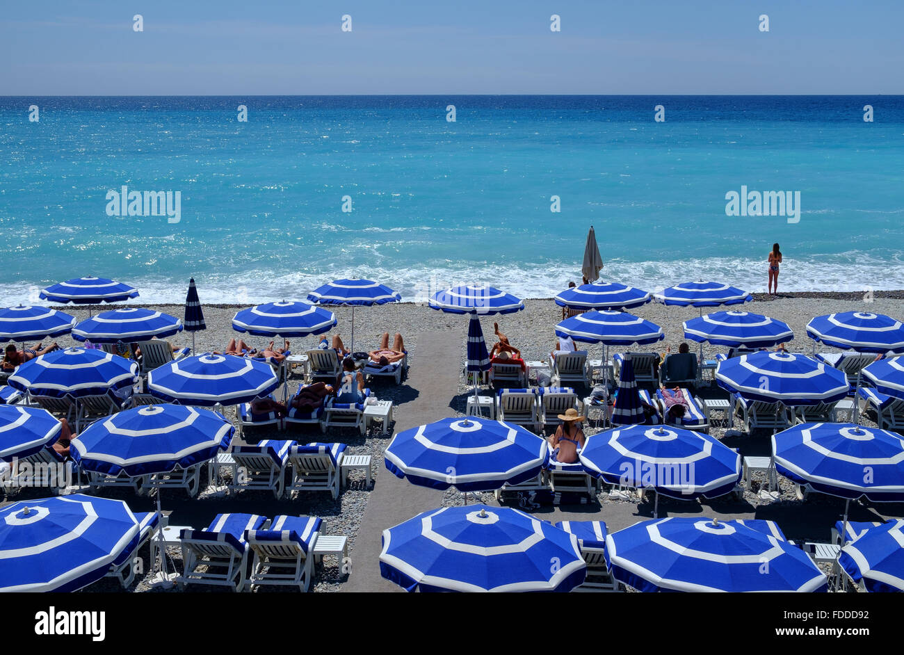 summer holiday beach umbrellas sunbathers sea sand Stock Photo