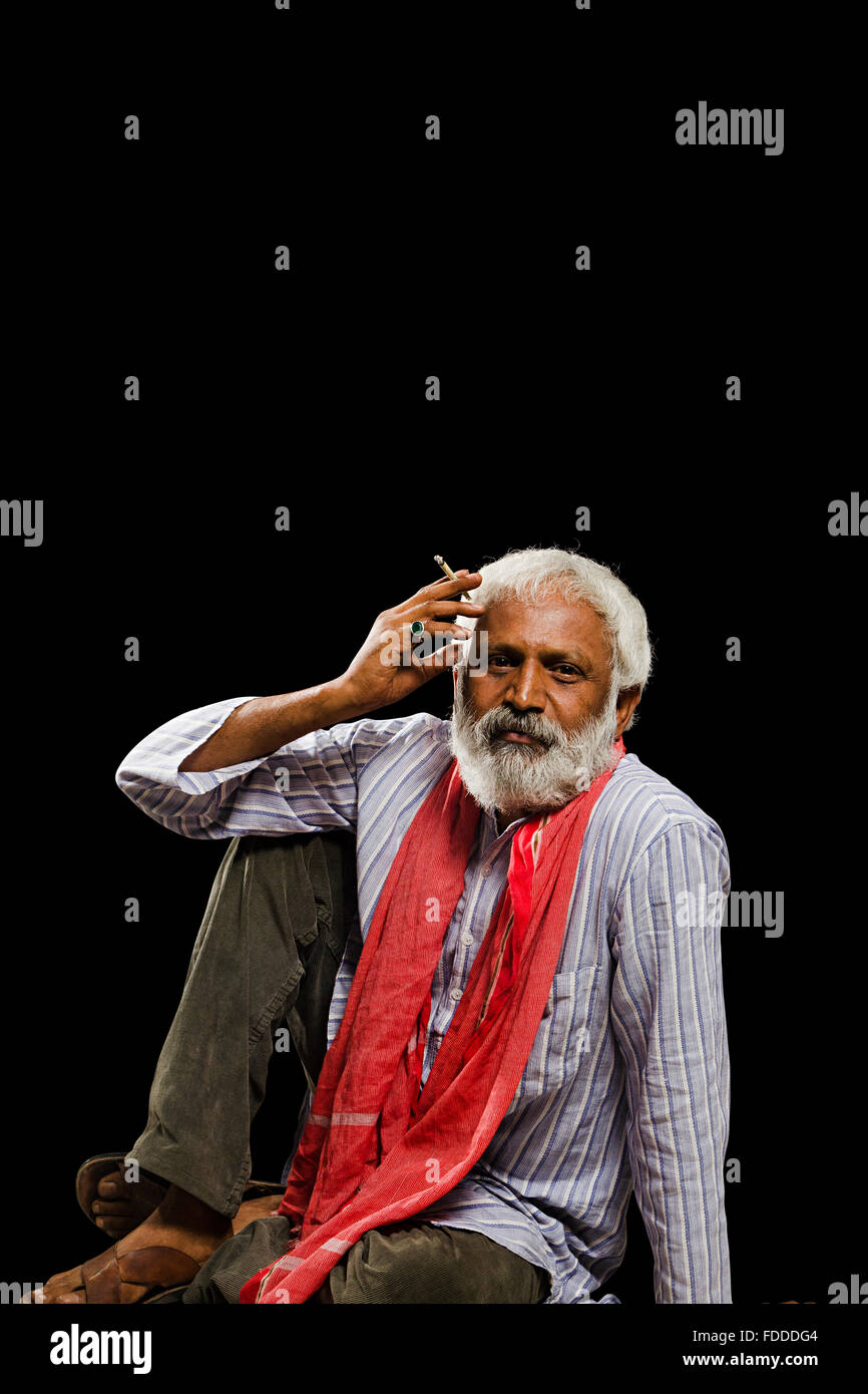 1 indian Senior Adult Man Villager Sitting Smoking Bidi Stock Photo